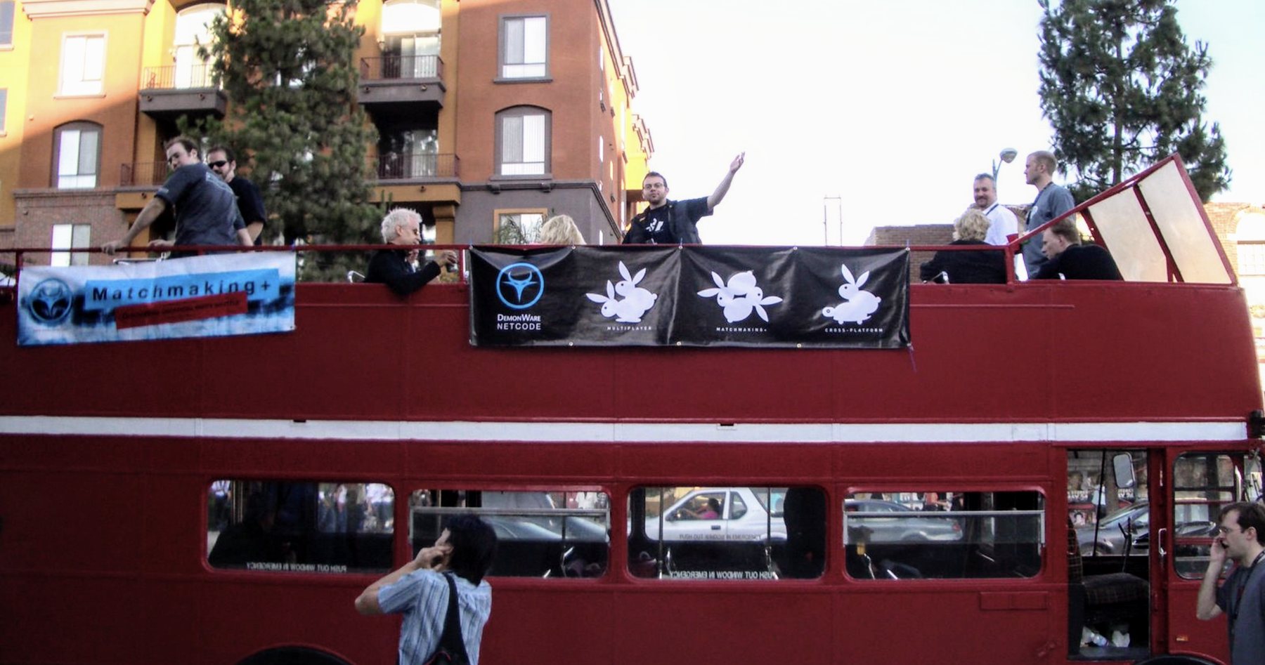 The Demonware team celebrating on a red double-decker bus at E3 in Los Angeles